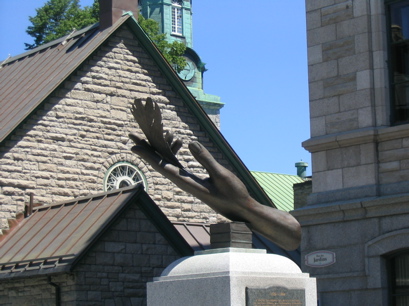 Bronze sculpture of feather in hand